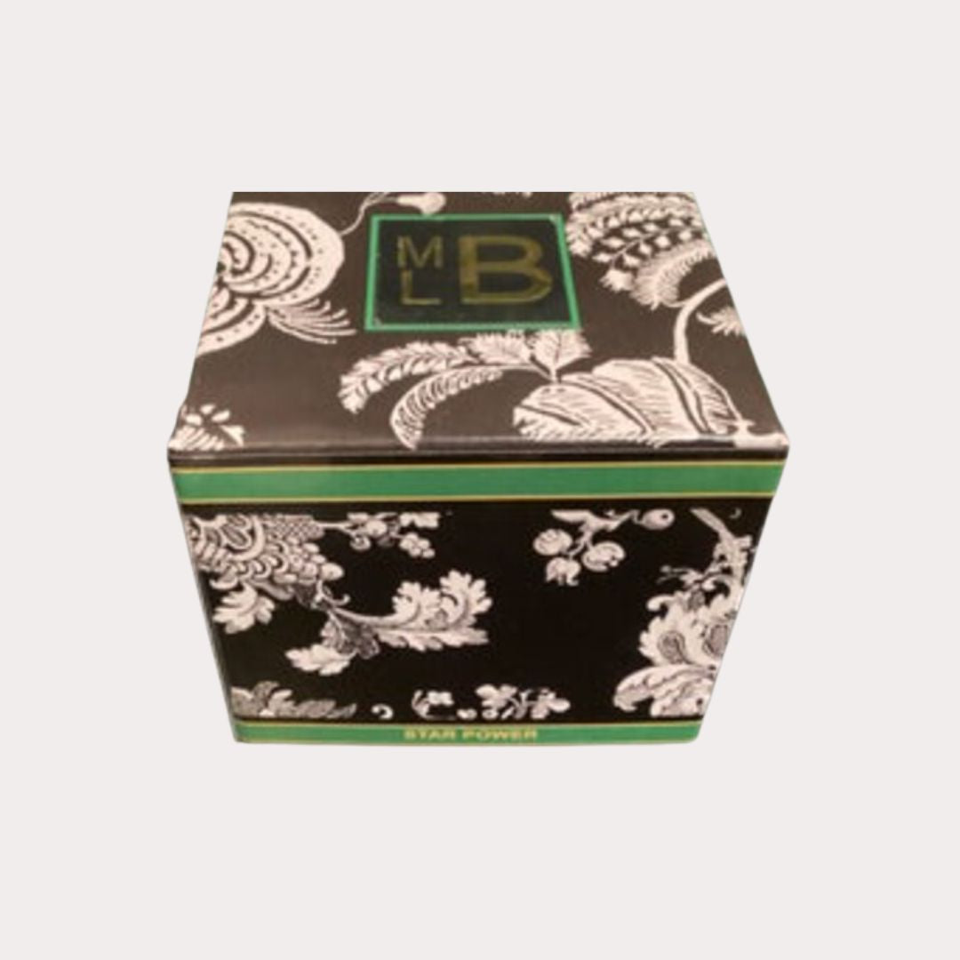Martyn Lawrence Bullard Star Power candle in decorative packaging featuring prints from the Star Style Book, evoking the sparkle of the festive season.